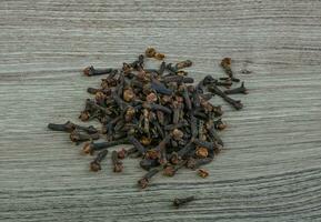 Cloves seeds on wooden background photo