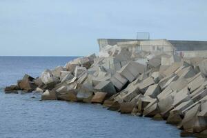 large chunks of concrete creating a harbour breakwater photo