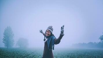Asian women relax in the holiday. Happy to travel in the holiday. During the foggy winter photo