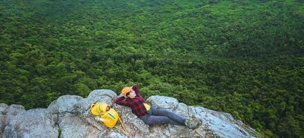 woman asians travel relax in the holiday. View mountain nature on the cliffs. photo