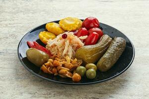 Plate with pickled vegetables and mushrooms photo