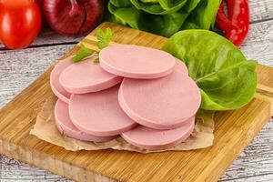 Slices boiled sausages for breakfast photo