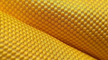 Yellow football apparel with air mesh texture. Sportswear background photo