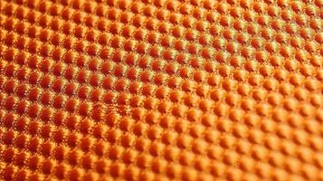 Orange soccer fabric texture with air mesh. Sportswear background photo