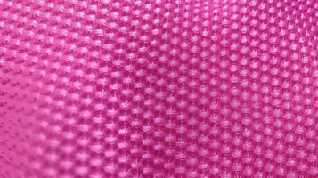 Pink football uniform with air mesh texture. Sportswear background photo