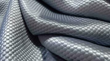 Grey soccer fabric texture with air mesh. Sportswear background photo