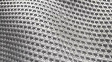 Grey soccer fabric texture with air mesh. Sportswear background photo