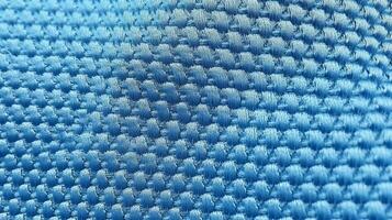 Blue soccer fabric texture with air mesh. Sportswear background photo