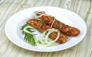 Beef kebab over wooden photo