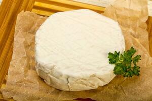 Camembert cheese over wooden photo