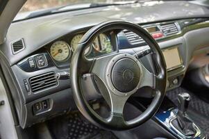 Car steering wheel and car sensors, inerior background, modern city car elements close view. Car inside interior photo