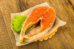 Raw salmon over wooden photo