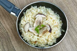 Mushroom risotto over wooden photo