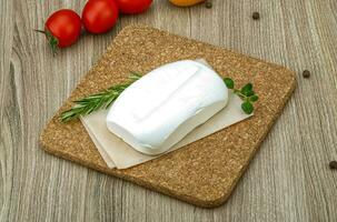 Feta cheese over wooden photo