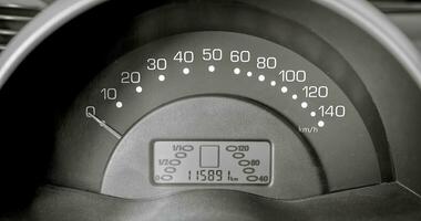 Car speedometer and sensors on a control panel background, car elements close view photo