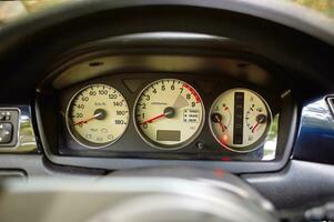 Car steering wheel and car sensors, inerior background, modern city car elements close view. Car inside interior photo