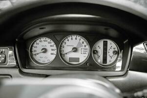 Car steering wheel and car sensors, inerior background, modern city car elements close view. Car inside interior photo