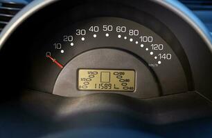 Car speedometer and sensors on a control panel background, car elements close view photo