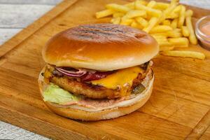 Burger with chicken, cheese and red onion photo