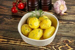 Boiled potato with oil and dill photo