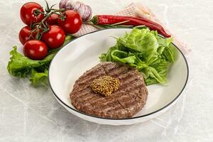 Frilled beef burger cutlet with iceberg photo