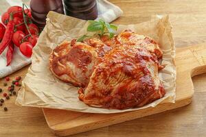 Marinated chicken leg in tomato sauce photo