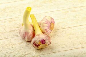 Garlic over wooden photo