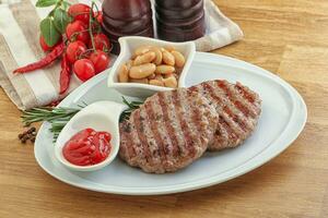 Grilled beef burger cutlet with sauce photo