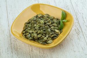 Pumpkin seeds in the bowl photo