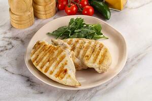 Grilled chicken breast served arugula photo