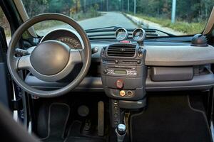 Shift lever, car steering wheel and sensors. Inside a modern car view, city car interior background photo