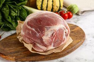 Uncooked raw pork knuckle with spices photo