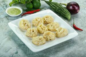 Nepali steamed dumplings  Momo with sause photo