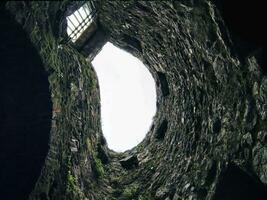 Stone well hole, old construction from inside, fall down in the well photo