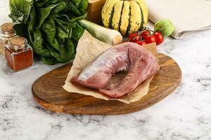 Uncooked raw pork tenderloin with spices photo