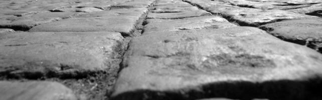 Road paved with old stones black and white background photo