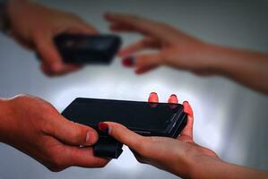 Man and woman exchange smartphones photo