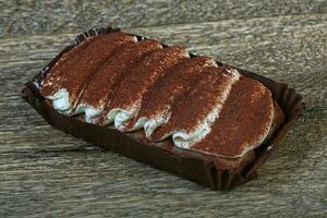 Tiramisu cake on wooden background photo