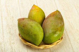 Mango on wooden background photo