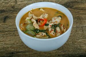 Red curry on wooden background photo