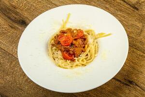 Spaghetti Bolognese on wooden background photo