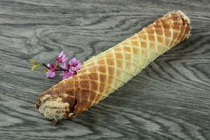 Wafer roll on wooden background photo