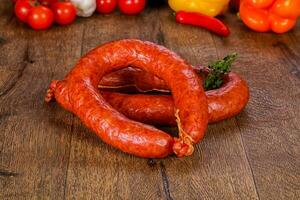 Pork sausages over wooden photo