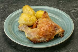 Roasted chicken leg with potato photo