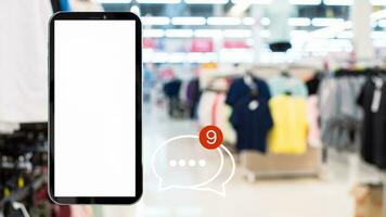 White screen smartphone with message icons isolated on background inside shopping mall. online shopping Website, marketplace platform, e-commerce technology and online payment concepts. photo