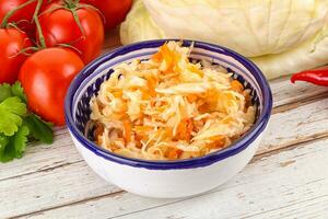 Fermented cabbage sauerkraut in the bowl photo