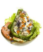 Seafood salad with red caviar in avocado photo