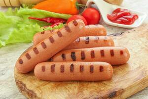 Grilled sausages with tomato sauce photo