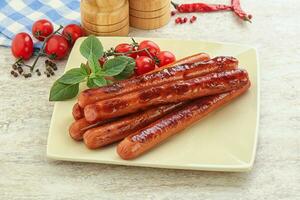 Roasted sausages in the plate photo