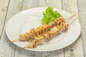 Grilled pork skewer served salad photo